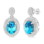 Load image into Gallery viewer, 7X5 MM Oval Cut Blue Topaz and 1/20 Ctw Round Cut Diamond Semi-Precious Earring in Sterling Silver