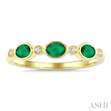 4X3 MM Oval Shape Emerald and 1/20 Ctw Bezel Set Round Cut Diamond Precious Fashion Band in 10K Yellow Gold