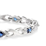 Load image into Gallery viewer, 4x3 MM Oval Cut Sapphire and 1/10 Ctw Round Cut Diamond Bracelet in 10K White Gold