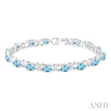 7X5 MM Oval Cut Blue Topaz and 1/20 Ctw Round Cut Diamond Fashion Bracelet in Sterling Silver