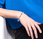 Load image into Gallery viewer, 5x3 MM Oval Cut Sapphire and 1/10 Ctw Round Cut Diamond Bracelet in 10K White Gold