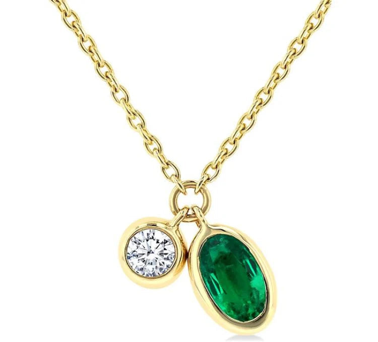 5x3 MM Oval Cut Emerald and 1/50 Ctw Bezel Set Round Cut Diamond Precious Pendant With Chain in 10K Yellow Gold