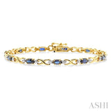 5x3mm Oval Cut Sapphire and 1/10 Ctw Single Cut Diamond Bracelet in 10K Yellow Gold